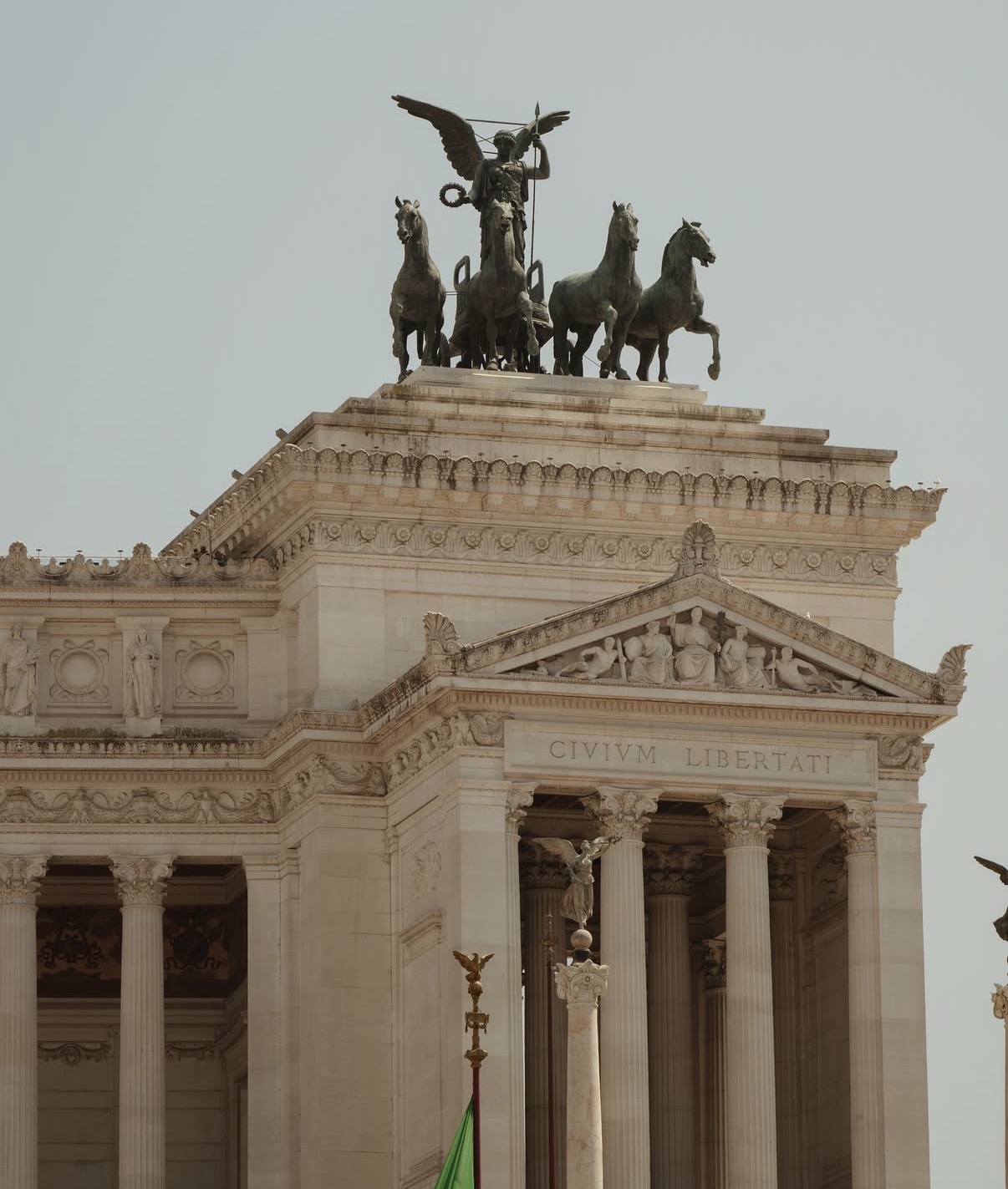 The Vittoriano in Rome, bronze quadriga against a pale morning sky