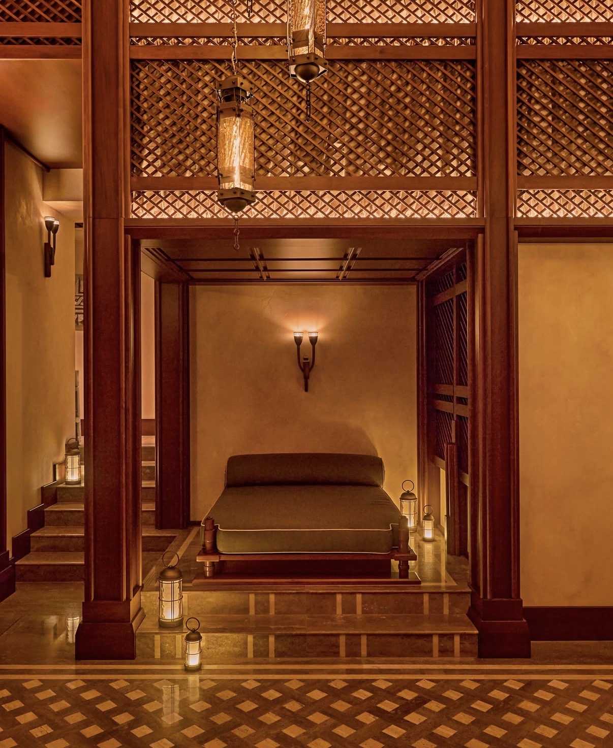 Lantern-lit treatment pavilion in carved wood within the palazzo spa