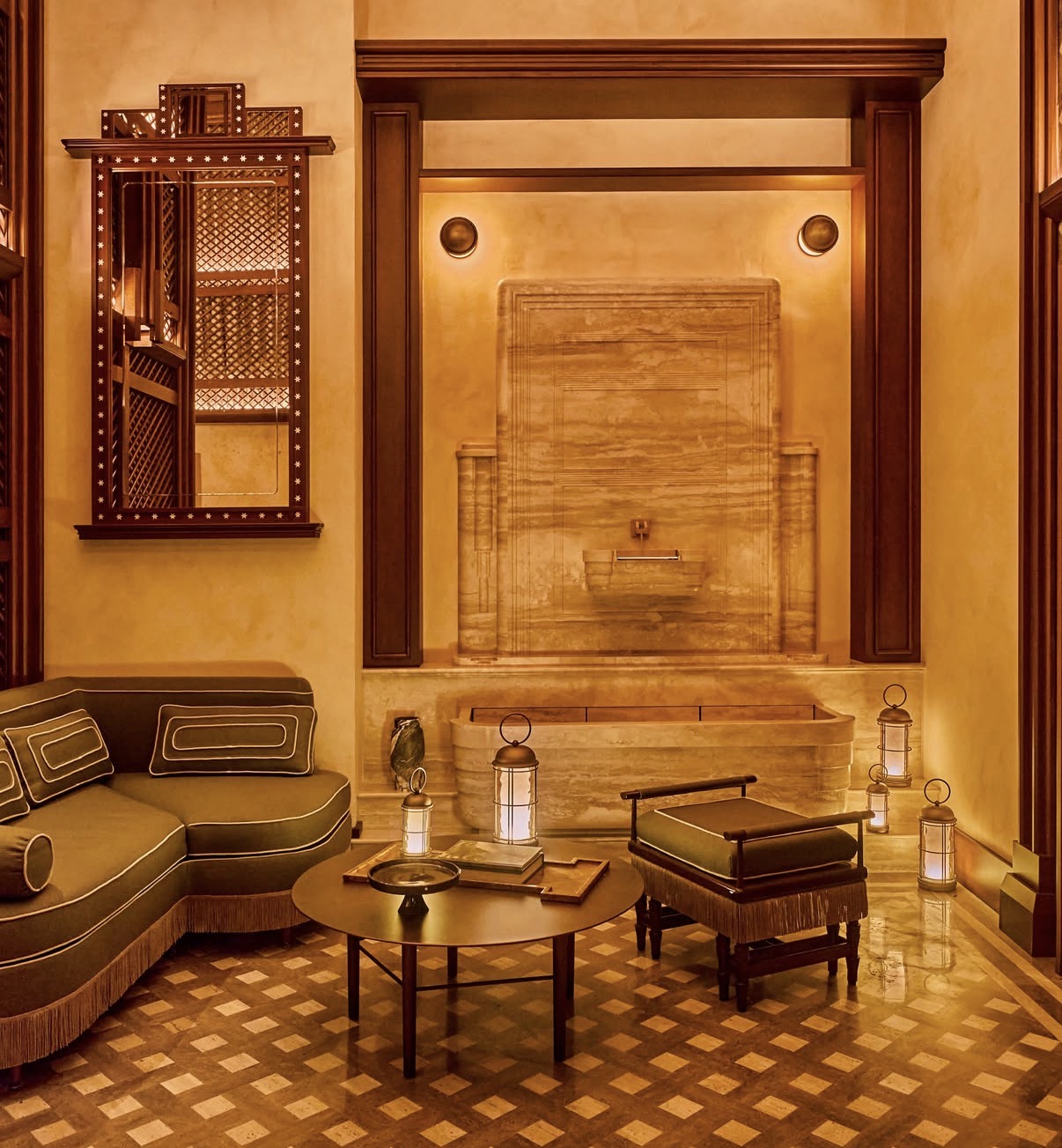 Sitting room with travertine fountain, olive banquette and brass lanterns
